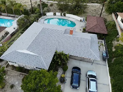 Tile roofing in progress with crew visible.